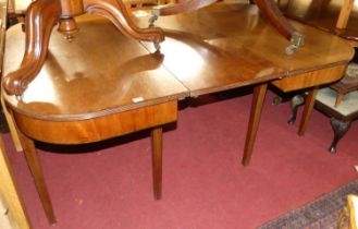 An early 19th century mahogany D-end extending dining table, having single extra drop-in leaf and
