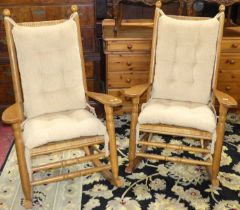 A pair of oak and woven rattan rocking open armchairs, each having detachable cushion backs and