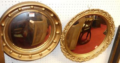 Two Regency style gilt decorated circular convex wall mirrors Both are modern and appear in good