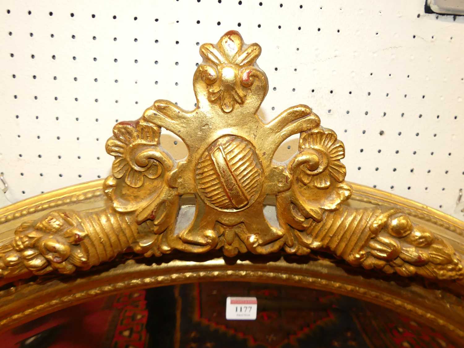 *A large contemporary profusely floral gilt decorated bevelled oval wall mirror, having pierced - Image 2 of 2