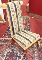 A mid-Victorian walnut framed and floral striped tapestry upholstered prie-dieu