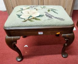 *A mahogany dressing stool, in the Georgian taste, having a floral needlework drop-in seat, raised