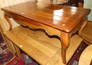 A contemporary French style cherry wood round cornered coffee table, on cabriole supports, length