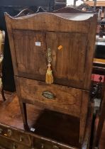 *A Regency mahogany gentleman's wash stand, having raised cut out handles over twin doors to lower