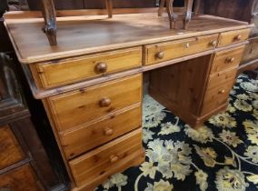 A modern pine round cornered kneehole writing desk, width 136cm