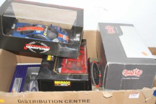 A box containing modern issue diecast to include a boxed 1:18 scale McLaren F1, a Burago Ferrari