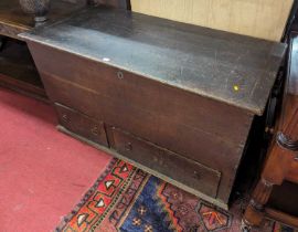 A 19th century provincial oak mule chest, the hinge top over two short lower drawers, width 136cm