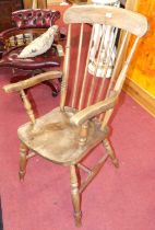 An early 20th century elm and beech stick back farmhouse open armchair, width 55cm