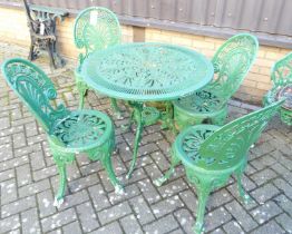 A green painted pierced galvanised metal patio suite comprising; circular table, dia. 80cm, and a