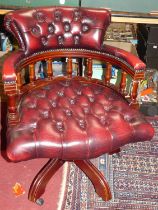 A contemporary mahogany burgundy red leather buttoned upholstered and further brass studded tub