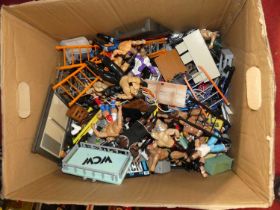 A box containing various wrestling figures and accessories