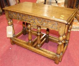 A contemporary Ipswich joined oak nest of three occasional tables, having relief carved frieze on