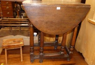 A 19th century joined oak dropflap gateleg occasional table; together with a small provincial yew