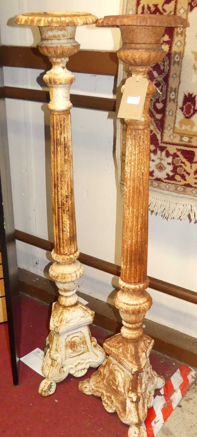 A pair of cast iron freestanding pricket floor sticks, in the classical taste, each with knopped and