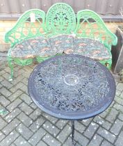 A green painted pierced galvanised metal three-seater garden bench of shaped form, all over floral