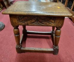 *A contemporary joined oak joint stool, in the 17th century taste, having floral relief carved