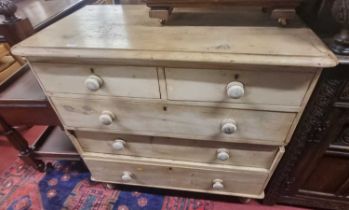 A Victorian pine round cornered chest of two short over three long drawers, raised on squat turned