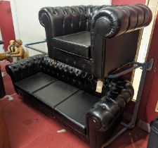 A contemporary black leather buttoned upholstered three-seater Chesterfield, having squab