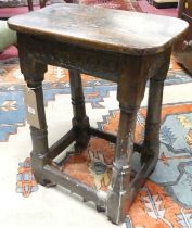 *An antique joined oak joint stool, having a rounded top, relief carved frieze and raised on