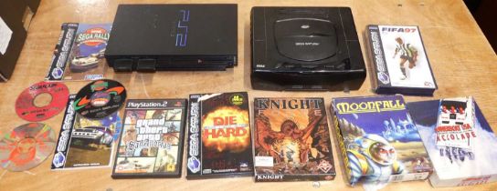 A box containing video game items to include Playstation 2 console, Sega Saturn console, etc