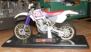 A plastic scale Honda XR400R on stand