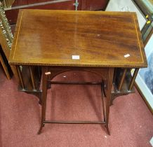 An Edwardian mahogany and satinwood inlaid book table, having opposing side supports and raised on
