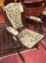 An early 20th century beech and floral needlework upholstered folding elbow chair, width 61cm