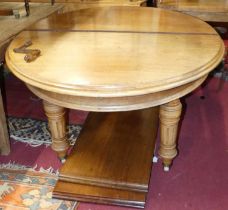 A mid-Victorian mahogany D-end extending dining table, having wind-out action, two extra drop-in