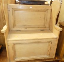 A rustic pine panelled bench settle, having typical hinged box seat base, w.92cm