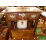 A George III oak three drawer lowboy, raised on chamfered square supports, w.73cm Slight wobble.Some