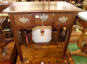 A George III oak three drawer lowboy, raised on chamfered square supports, w.73cm Slight wobble.Some