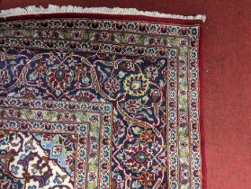 A large Persian blue, red and cream ground Keshan rug, 356 x 353cm (9sq metres) In used but