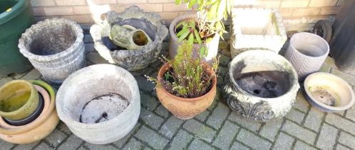 A collection of sundry stone, terracotta and other plant pots