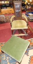 An early 20th century Spanish walnut tub armchair, the embossed tan leather pad back with brass