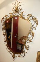 A contemporary floral wired and scroll gilt metal framed shaped wall mirror, in the French taste,