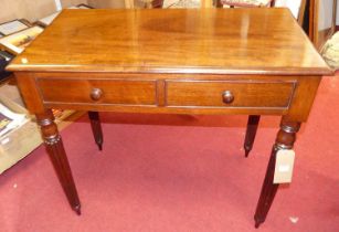 A Victorian mahogany two-drawer side table, raised on turned and reeded slightly tapering