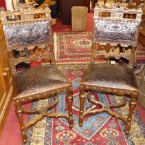 A set of six circa 1900 provincial Spanish walnut dining chairs, each with floral embossed tan