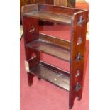 A 1930s stained oak small three-tier open bookshelf, with pierced cut-out end detail, w.55cm