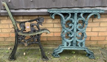 A pair of black painted pierced cast iron bench ends, together with a pair of green painted cast