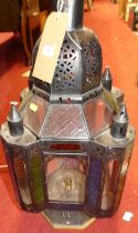 A painted metal lantern, of square section with coloured glass panes, fitted for electricity, w.