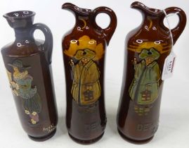 A pair of Doulton Kingsware for Dewars Scotch Whisky ewers, featuring The Nightwatchman, height 27cm