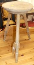 A beech three-legged milking stool, h.54cm