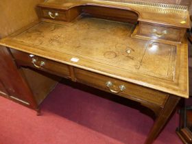 A circa 1900 mahogany and satinwood crossbanded lady's writing table, having pierced brass three-