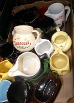 Two fruit trays containing a selection of whisky related advertising jugs to include Black &