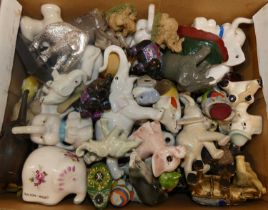 A collection of ceramic and wooden elephant ornaments in two boxes