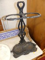 A black painted wrought iron twin division stickstand, of floral scroll form, height 69cm