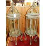 A pair of contemporary Verdigris metal domed circular hanging birdcages, raised on scroll