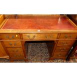 A circa 1900 walnut and gilt tooled burgundy leather inset kneehole writing desk, having typical