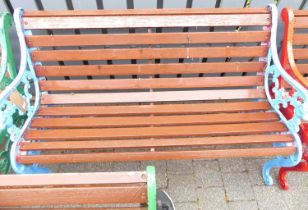 A blue painted pierced and cast iron ended and stained slatted wood two-seater garden bench, width