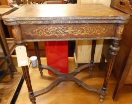 A French Louis XVI style floral penwork decorated and further brass mounted fold-over games table,